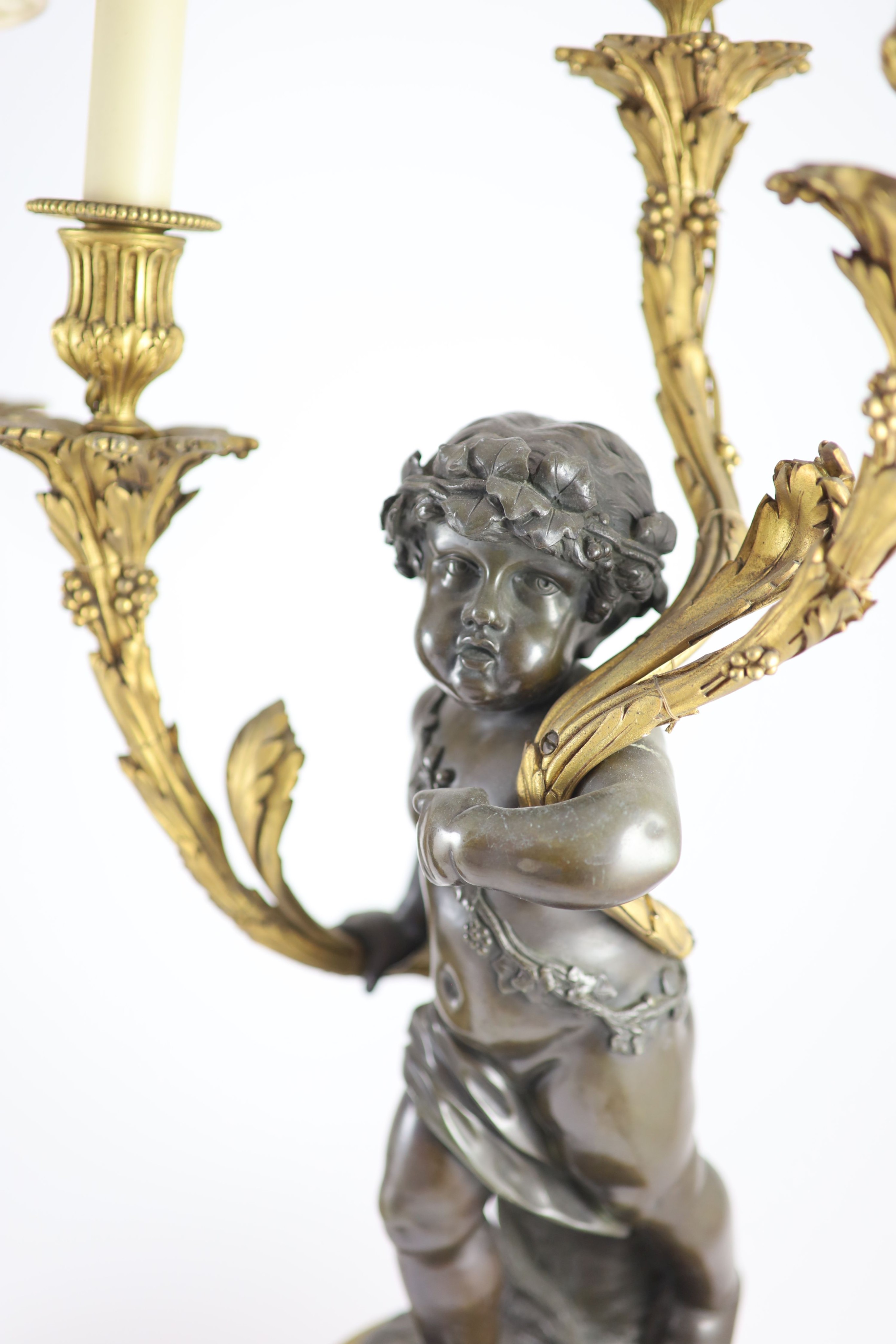 A pair of 19th century French bronze and ormolu three light candelabra, after Clodion height 66cm